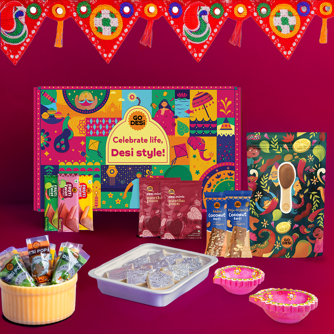 17 Items | DESi Fun Diwali Gift Box | By GO DESi | Diwali Diya Set | Toran | Kaju Katli | DESi POPz: Tangy Imli, Real Aam, Kaccha Aam | Badam Coconut Barfi | Kaju Kishmish Coconut Barfi | Meetha Paan | Fruti Twist: Real Aam, Kaccha Aam, Guava